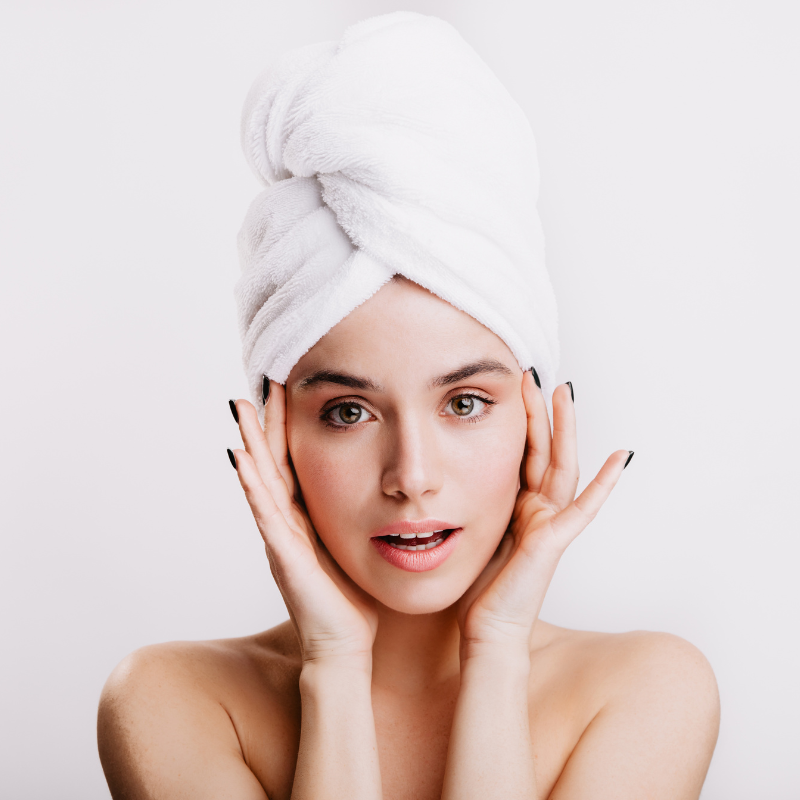 Femme avec serviette sur la tête, peau fraîche.