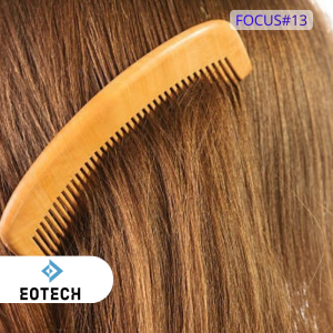Peigne en bois dans des cheveux bruns